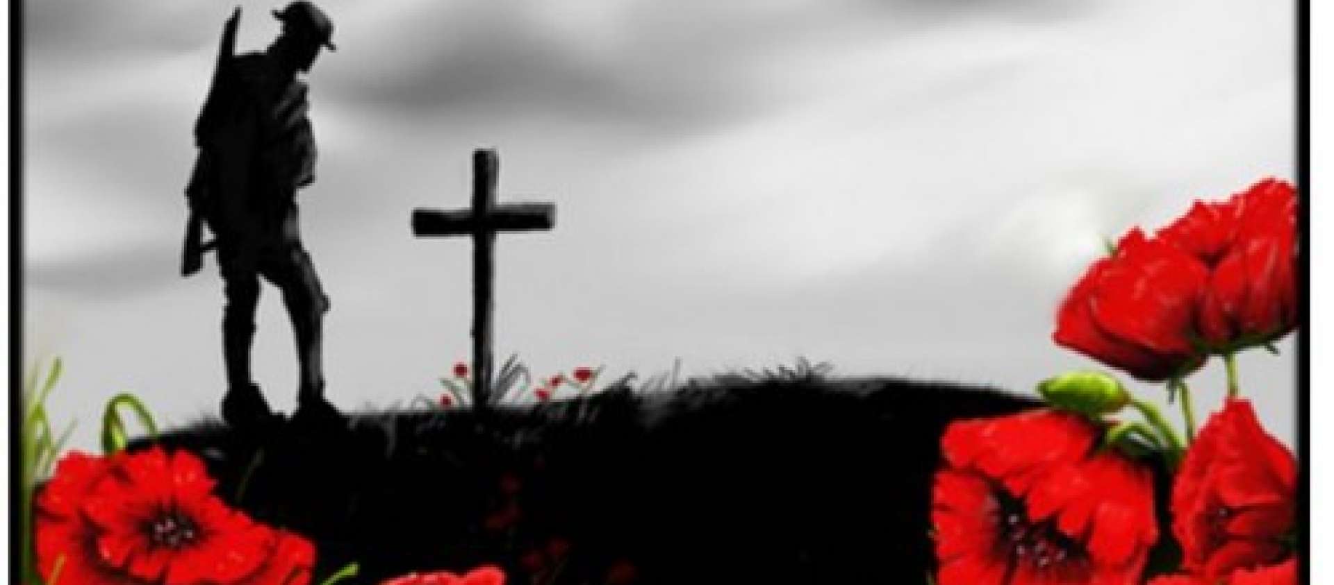 Photo of soldier in front of grave marker with poppies in foreground
